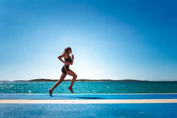 Woman running showing strong leg muscle Shepperton Green